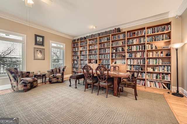 397 4th St NE, Atlanta, GA 30308 - sitting room featuring wall of books, crown molding, wood finished floors, and a ceiling fan
