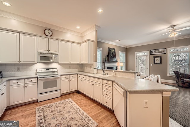 397 4th St NE, Atlanta, GA 30308 - kitchen with white appliances, a peninsula, open floor plan, light countertops, and tasteful backsplash