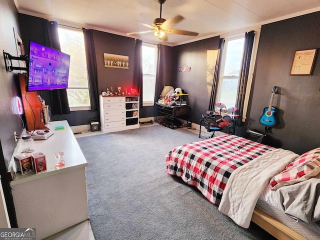 carpeted bedroom featuring multiple windows, ceiling fan, and baseboards