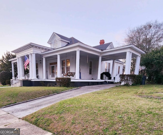 neoclassical home with driveway, a porch, crawl space, and a front yard