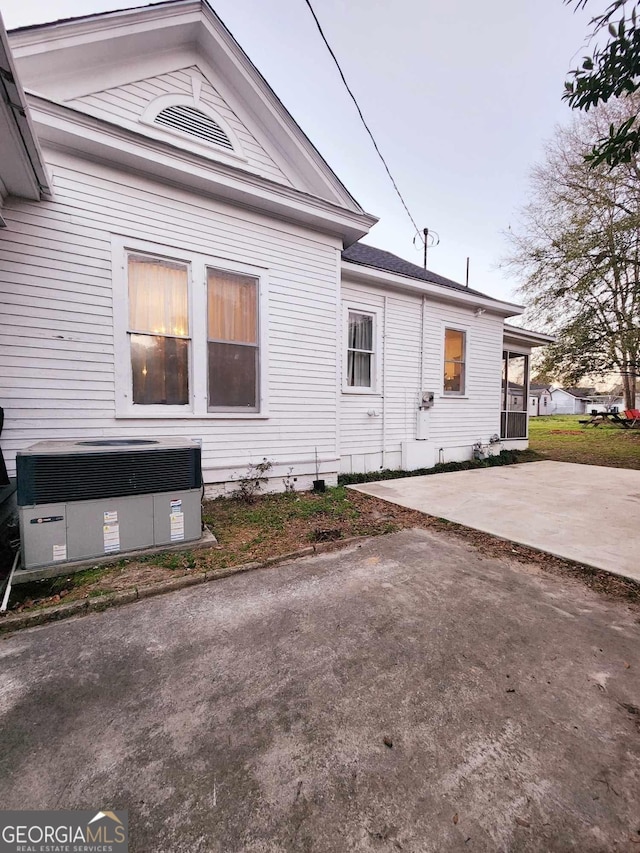 view of property exterior featuring a patio and central AC unit