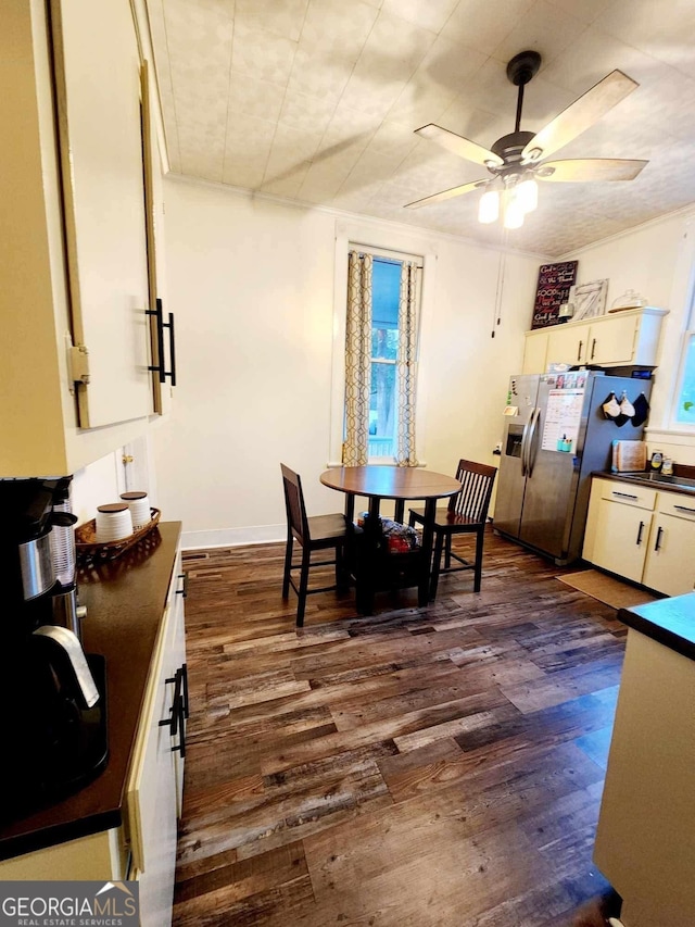 dining space featuring dark wood-style floors, ceiling fan, and baseboards