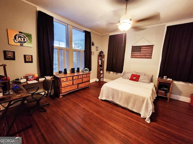 bedroom with a view of city, a ceiling fan, baseboards, dark wood-style floors, and crown molding