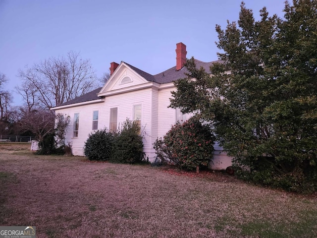 view of property exterior featuring a chimney