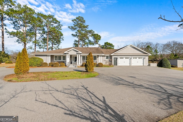 single story home featuring aphalt driveway and an attached garage