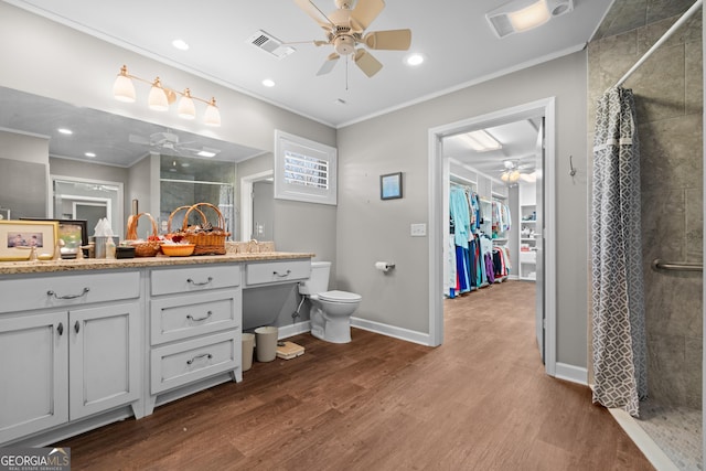 full bath featuring wood finished floors, a shower stall, visible vents, and a ceiling fan