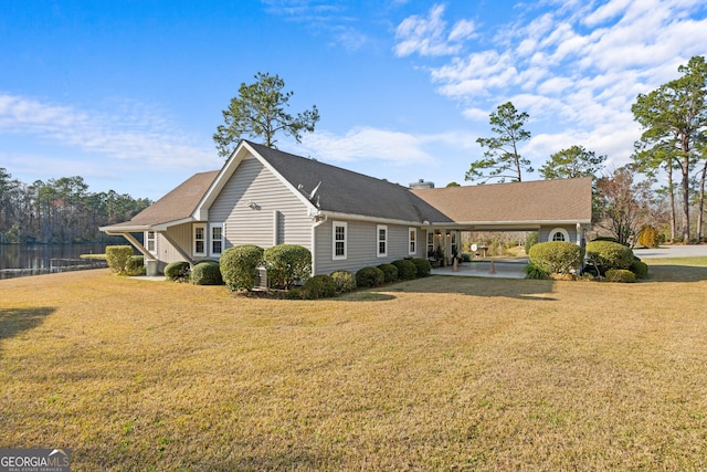 exterior space with a chimney, an attached carport, and a front yard