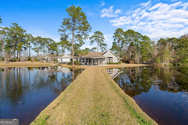 view of dock featuring a water view and a lawn