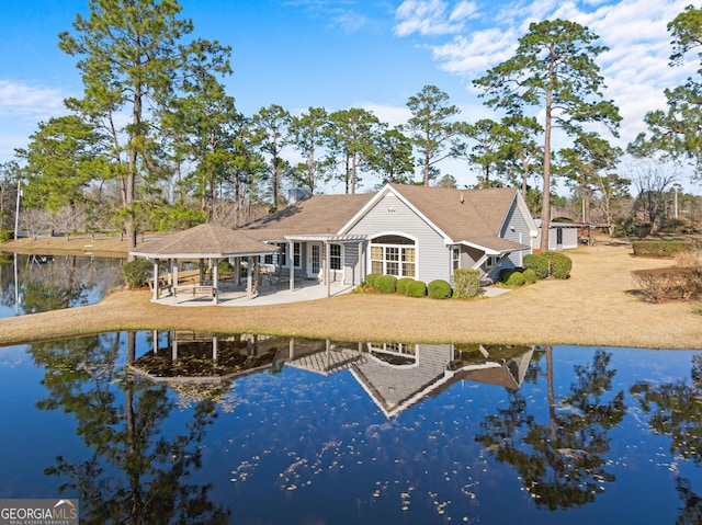 back of house featuring a water view and a gazebo