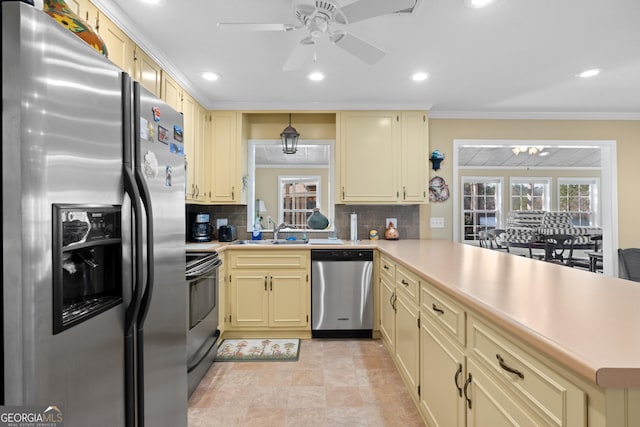 kitchen featuring light countertops, appliances with stainless steel finishes, and a peninsula