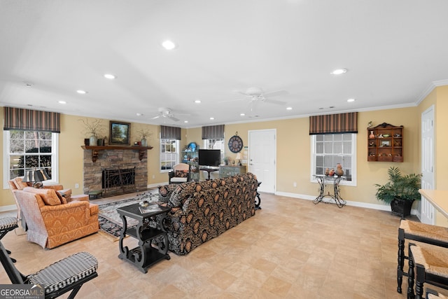 living area with recessed lighting, baseboards, crown molding, and a stone fireplace