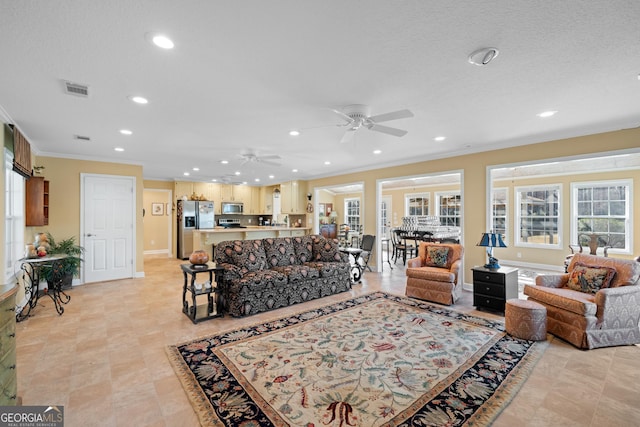 living area with recessed lighting, visible vents, crown molding, and baseboards