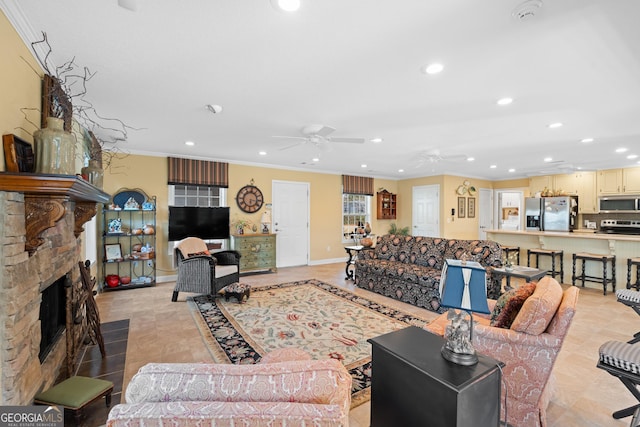 living room featuring ornamental molding, recessed lighting, a fireplace, and ceiling fan