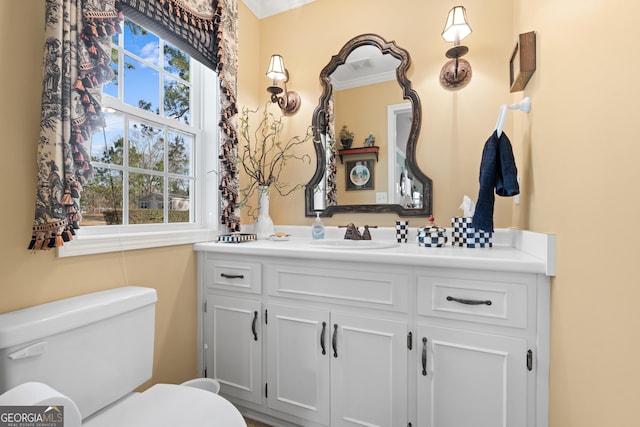 half bath featuring toilet and vanity