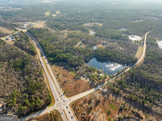 aerial view featuring a water view and a forest view