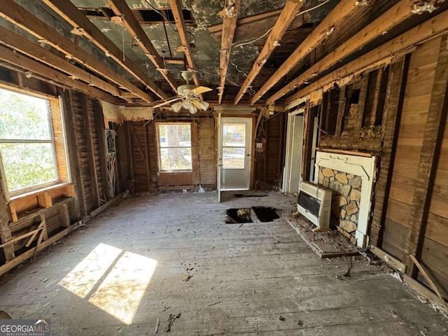 unfurnished living room with heating unit and a healthy amount of sunlight