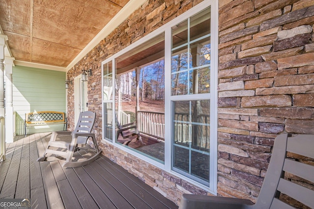 wooden terrace featuring covered porch