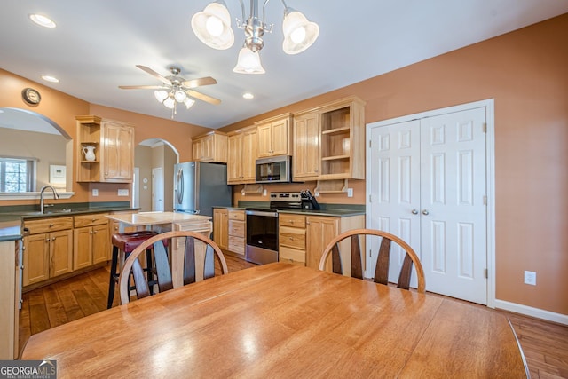 kitchen with open shelves, a ceiling fan, appliances with stainless steel finishes, and dark wood-style flooring