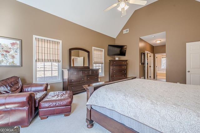 carpeted bedroom with visible vents, multiple windows, and high vaulted ceiling