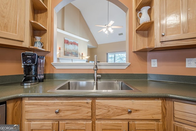kitchen with open shelves, a sink, vaulted ceiling, and dark countertops