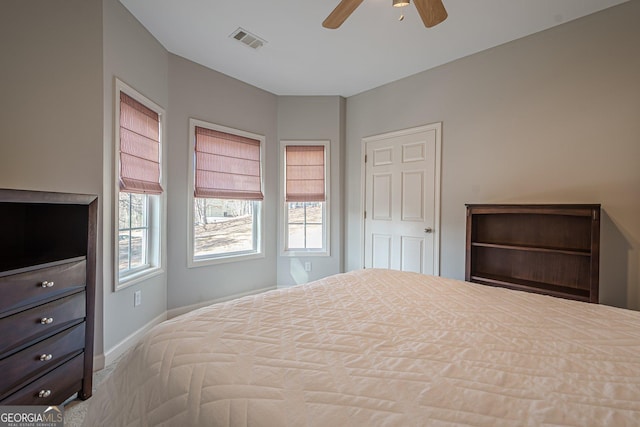 bedroom with visible vents, baseboards, and a ceiling fan