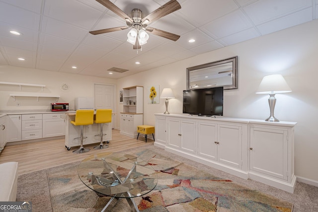 living area featuring a ceiling fan, a desk, recessed lighting, baseboards, and light wood finished floors