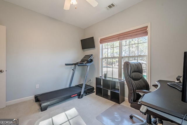 carpeted home office featuring baseboards, visible vents, and ceiling fan