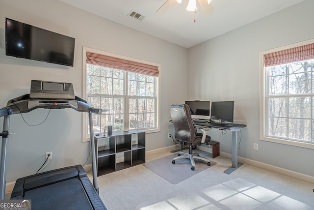 office with baseboards, visible vents, carpet floors, and ceiling fan