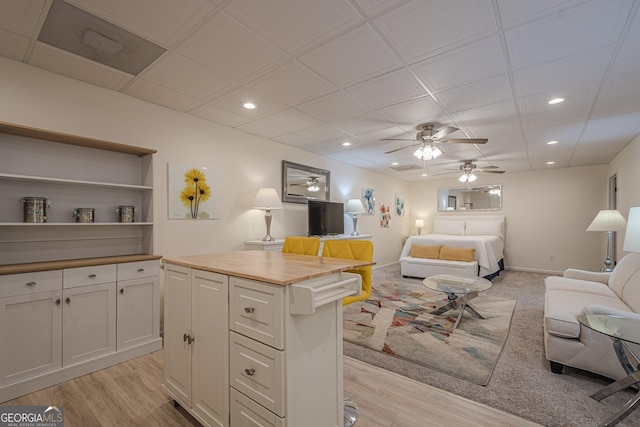 bedroom with recessed lighting, light wood-style floors, and baseboards