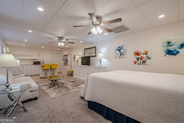 bedroom featuring recessed lighting, light colored carpet, and an office area