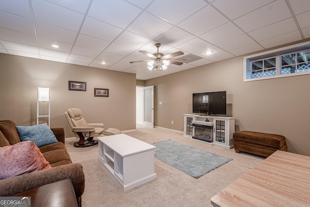 living room with light colored carpet, a paneled ceiling, a ceiling fan, recessed lighting, and baseboards
