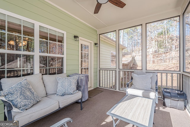 sunroom / solarium featuring ceiling fan