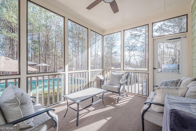 sunroom / solarium featuring ceiling fan