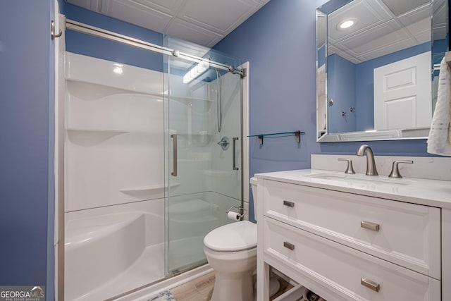 full bathroom with a shower stall, toilet, vanity, recessed lighting, and wood finished floors