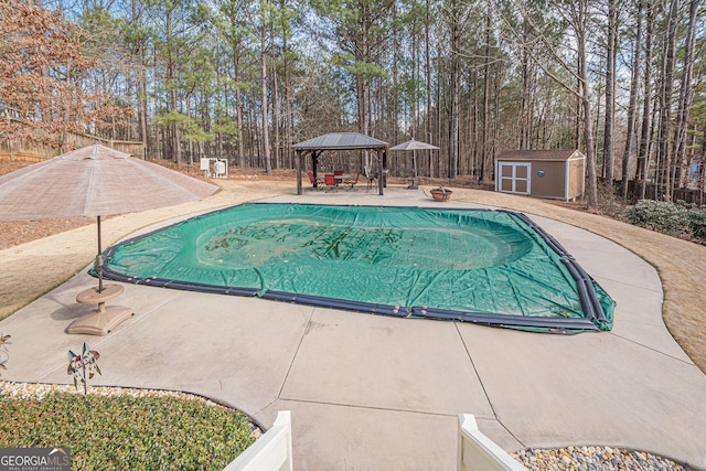 pool with fence, a gazebo, an outdoor structure, a storage shed, and a patio area