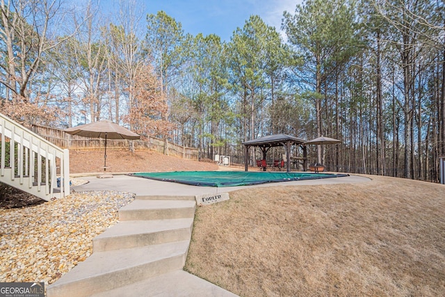 view of swimming pool with a gazebo, a fenced backyard, and a patio area