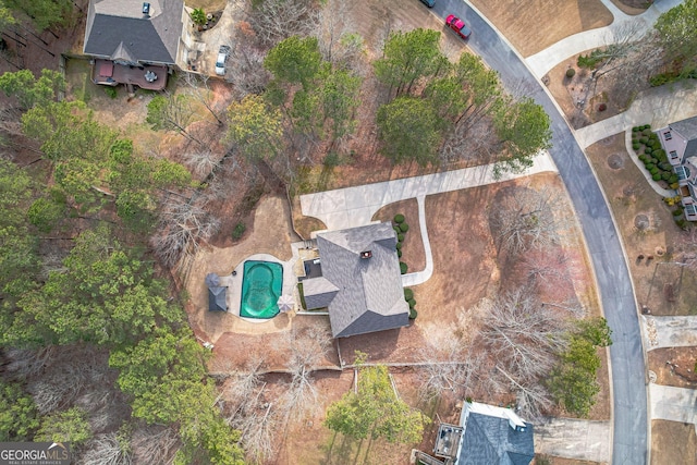 aerial view of property and surrounding area featuring a pool area