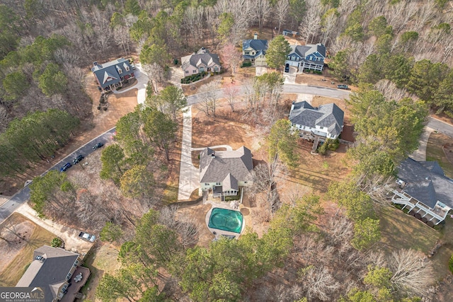 view of property location with a pool and nearby suburban area