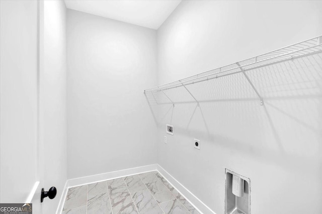 washroom featuring hookup for a washing machine, light marble finish flooring, baseboards, and hookup for an electric dryer