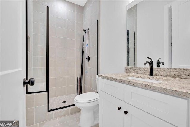 bathroom featuring a shower stall, toilet, vanity, and tile patterned floors