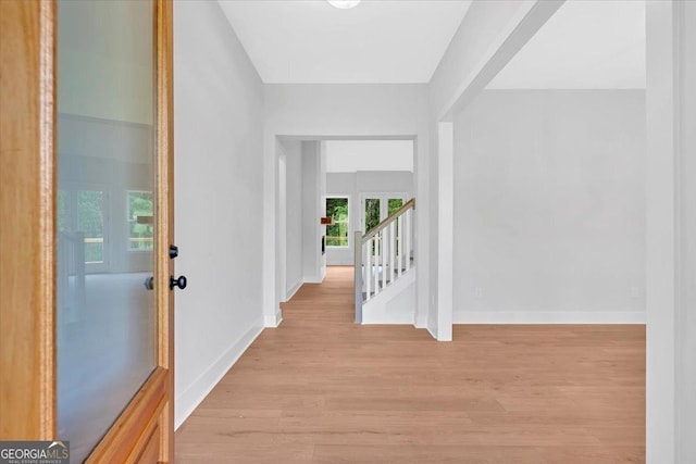 entrance foyer with french doors, light wood finished floors, and baseboards
