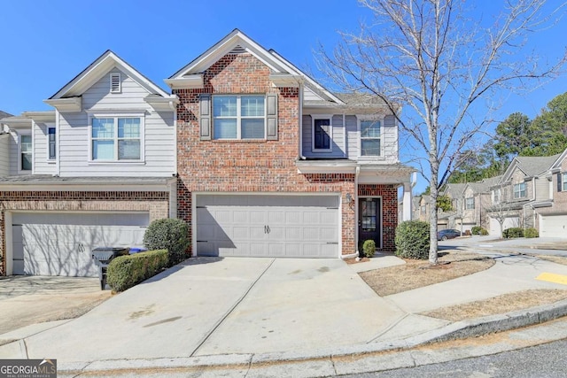 view of front facade featuring an attached garage, concrete driveway, and brick siding