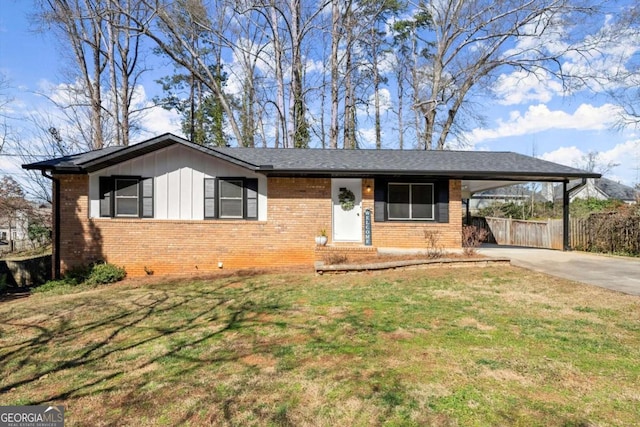 ranch-style house featuring a carport, concrete driveway, brick siding, and a front lawn