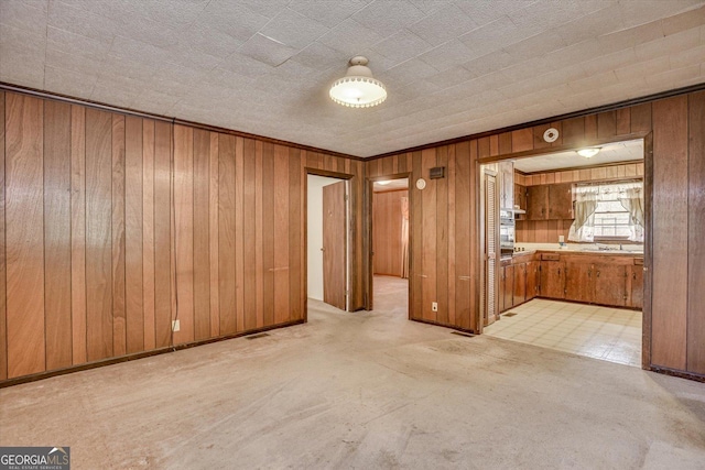 unfurnished room featuring wooden walls