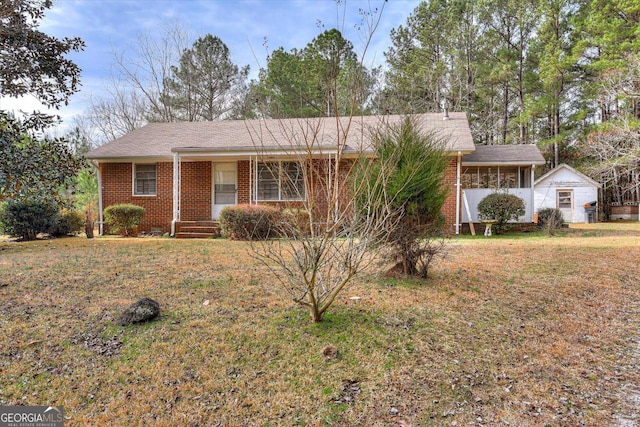 ranch-style house with brick siding and a front yard