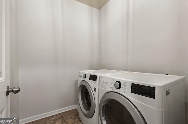 laundry area featuring laundry area, baseboards, and washer and dryer