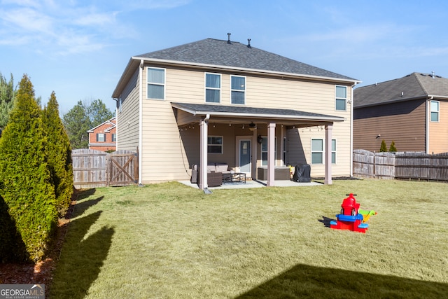 back of house featuring a fenced backyard, a patio, a lawn, and an outdoor hangout area