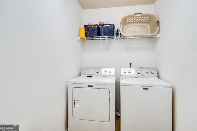 washroom featuring laundry area and washer and clothes dryer