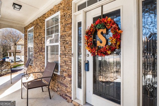 property entrance featuring stone siding