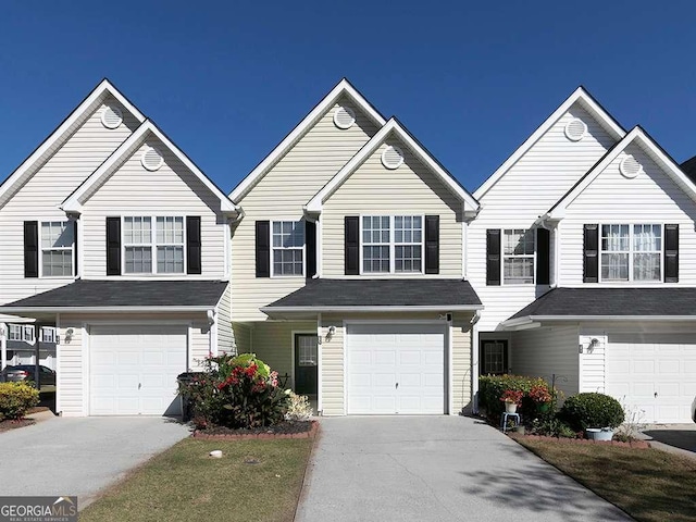 view of front facade with concrete driveway and an attached garage